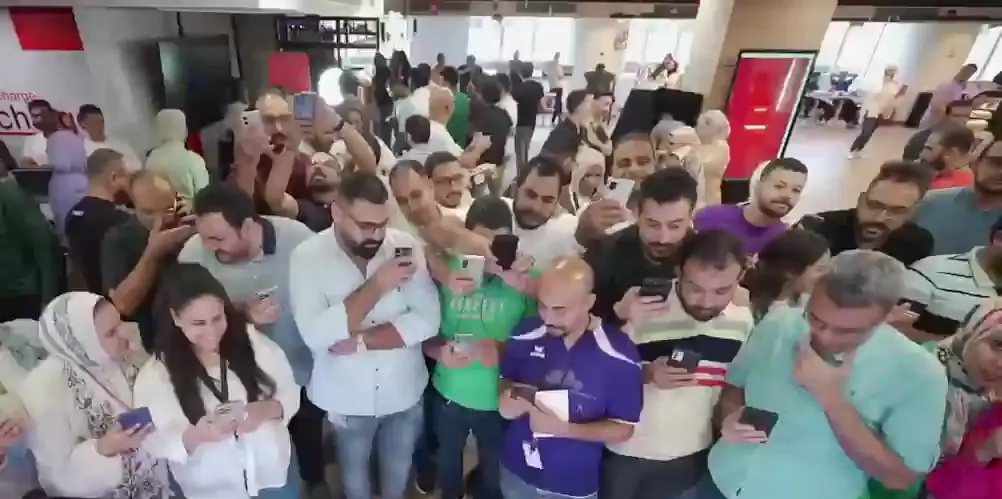 Large crowd of colleagues playing a group game together on their phones